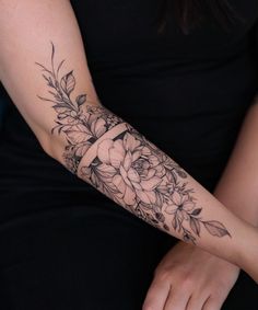 a woman's arm with flowers on it