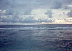 the sky is cloudy over the ocean with waves