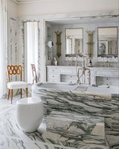 an elegant bathroom with marble floors and walls