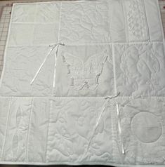 the quilt is being made with scissors and thread