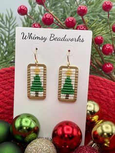 Introducing our fabulous and festive Christmas Tree Earrings. Hand beaded using premium seed beads and golden brass accents, these playful and gorgeous earrings add an extra touch of charm to your holiday ensemble. The perfect gift option, these eye-catching earrings make for an ideal stocking stuffer or a thoughtful present for a loved one. With these festive holiday earrings, you're sure to make a statement and spread joy wherever you go! Choice of with bow or without ✔️1 5/8 inches long & 5/8 Holiday Beaded Dangle Jewelry, Festive Drop Earrings With Gold Beads, Christmas Beaded Dangle Jewelry, Beaded Dangle Christmas Jewelry, Holiday Dangle Beaded Earrings, Holiday Handmade Earrings For Celebration, Beaded Jewelry For Christmas Celebrations, Handmade Earrings For Holiday Celebrations, Festive Beaded Holiday Jewelry