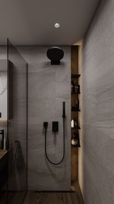 a bathroom with a walk in shower next to a sink and wooden shelves on the wall