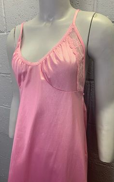 Vintage pink nylon nightgown. Semi sheer pink nylon. Low cut scoop neck trimmed in petite lace. Maxi length with hem sitting about mid shin. Low back with elastic. Good condition with some scratches/snags in the nylon under the bust that can be seen in pics. Fits most like a size small. Laid flat and measured. Bust (armpit to armpit) - 16-17 inches Waist - 15 inches Hips - 22 inches Length - 49 inches Sheer Pink Sleeveless Nightgown, Pink V-neck Nightgown, Pink Sleeveless Vintage Nightgown, Pink Sheer Vintage Nightgown, Pink Nightgown, Vintage Pink V-neck Nightgown, Rose Vintage, Lace Maxi, Pajama Robe