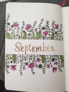 an open notebook with flowers and the word september written on it