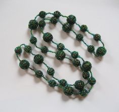 This is a fabulous beaded necklace featuring seed beads that have been woven around larger round beads. The necklace is done in green, blue green, and AB black tube shaped seed beads. This was purchased in an open market in France in the 1980's, a hand made piece from France. It is not marked or signed.The necklace is 37 inches. The large round beads are 17 mm, the smaller round beads are 14 mm.The necklace is in fabulous condition. There are no missing seed beads, the weaving is strong and has Green Beaded Necklace With Large Round Beads, Open Market, Black Tube, Seed Bead Necklace, Bead Necklace, Seed Bead, Round Beads, Seed Beads, Hand Made