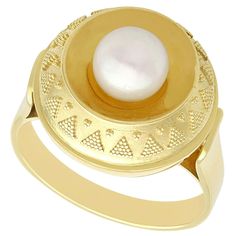 An impressive vintage 1960s cultured pearl and 14 karat yellow gold cocktail ring; part of our diverse pearl jewelry and estate jewelry collections. This fine and impressive vintage pearl ring has been crafted in 14k yellow gold. The rounded setting displays a feature 7.6mm cultured pearl to the center of a concave design. The concave setting is surrounded by a domed border, embellished with an applied bead decoration. The pierced decorated, elevated and flared ring shoulders integrate with the main setting and blend seamlessly with the plain ring shank. The ring is hallmarked to the interior of the shank with the 14k gold fineness mark. Images do not always reflect the true color and brilliance of gemstones and diamonds. The video however provides a truer representation of the actual colo Vintage Pearl Jewelry, Pearl Cocktail Ring, Yellow Gold Dress, Pearl Rings Vintage, Crossover Diamond Ring, Yellow Gold Cocktail Ring, Vintage Cocktail Ring, Gold Rings Fashion, Gold Cocktail Ring