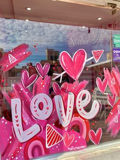 a window display with pink and white letters