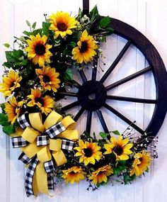 a sunflower wreath hanging on the side of a door