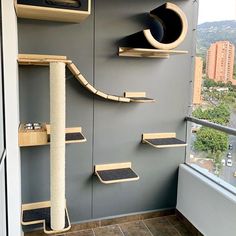 a cat tree in the corner of a room with several shelves and scratching pads on it