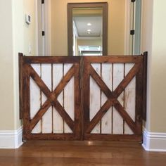 a large wooden gate in the middle of a hallway