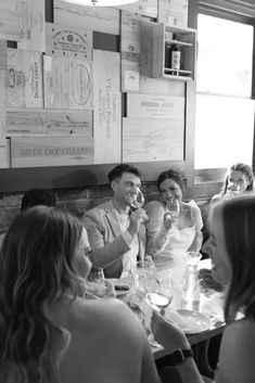 a group of people sitting around a table drinking wine