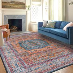 a living room filled with furniture and a blue couch next to a fire place in a fireplace