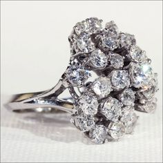 "Whenever I see a ring like this one, it really gets me to wondering. The stones in this ring are all old European cut diamonds, probably cut around 1880-1910, and yet this ring surely was made in the 1950s or 60s, so how did these diamonds end up here? What is their back story? Were they part of a Belle Époque brooch, links of a Victorian diamond bracelet, drops of an Edwardian necklace, a single fabulous earring whose mate was lost somewhere along the way? I guess in truth neither you nor I wi Dazzling Platinum Diamond Ring With Rose Cut Diamonds, Timeless Cluster Rings With Rose Cut Diamonds, Luxury Rose Cut Diamonds Cluster Wedding Ring, Luxury Platinum Cluster Ring With Rose Cut Diamonds, Edwardian Necklace, Retro 3, Diamond Bows, French Retro, Bow Ring