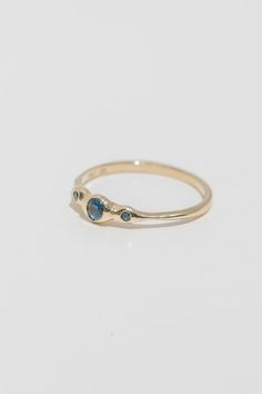 Named after the greek isle, the Rhodes is a delicate three stone ring in recycled gold. Each gem is nestled into the hand formed setting, where the gold "hugs" the precious stones into place. Each ring is made to order, please allow 4-6 weeks for delivery. Available with either post-consumer recycled white diamonds, lab-grown diamonds, Montana blue sapphires, or Teal Tourmaline. Total carat worth approx .15. Please leave note at checkout indicating ring size, happy to offer you half and quarter 14k Gold Three Stone Round Band Jewelry, Yellow Gold Three Stone Stackable Promise Rings, 14k Gold Three Stone Cluster Ring, Minimalist Three-stone 14k Gold Ring, Three Stone 14k Gold Round Band Jewelry, 14k Gold Hand Forged Promise Ring, Minimalist Three Stone 14k Gold Rings, 14k Gold Three Stone Stackable Rings For Anniversary, Three Stone 14k Gold Promise Rings