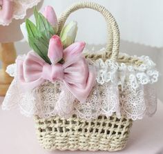 a small basket with pink flowers in it