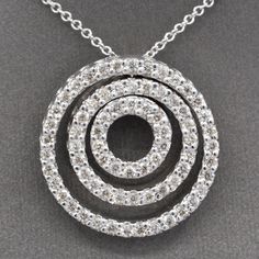 "Three Concentric Circles Diamond Pendant Necklace in 14k White Gold This necklace brings all the sparkle and bling!  Three concentric circles are attached at the top (the middle circle floats) to form a dynamic and powerful piece.  The circles are encrusted with natural earth-mined diamonds measuring 1.5mm each, for a total approximate carat weight of 72 stones equaling 1.08cttw.  The diamonds are fully cut round brilliant, H/I color and SI2 average clarity.  There are no eye visible inclusions Spiral Brilliant Cut Jewelry For Anniversary, Spiral Jewelry With Brilliant Cut For Anniversary, White Gold Jewelry With Brilliant Cut In Spiral Shape, Fine Jewelry With Spiral Brilliant Cut, Fine Jewelry Spiral Diamond Jewelry, Fine Jewelry With Diamond Accents In Spiral Shape, Spiral White Gold Jewelry With Brilliant Cut, Fine Jewelry With Spiral Diamond Accents, White Gold Spiral Jewelry With Brilliant Cut