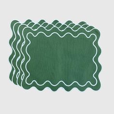 a green placemat with wavy lines on it and a white border in the middle