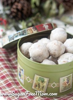 a green bowl filled with snowballs on top of a red and white checkered table cloth