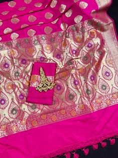 Beautiful Pink color Banarasi Handloom Saree with Gold Zari Weaving Buttas and floral borders with Meenakari Work. The pallu of the saree is grand and with Meenakari Work. Material is very soft and easy to drape and carry. Item : SareeColor : PinkBase Fabric : Soft Banarasi Silk Blouse piece : Comes with Blouse pieceBlouse material : Soft Banarasi Silk Fall & Edging: Comes with Fall and edging (Pico) and tassels attached Occasion: Party, Wedding, Festival, Wedding, Traditional, Religious, House- Pink Paithani Silk Saree With Meenakari Details, Pink Handloom Paithani Silk Dupatta, Paithani Silk Saree With Embroidered Border, Luxury Paithani Silk Saree With Border, Luxury Semi-stitched Paithani Silk Saree, Bandhani Saree, Kantha Stitch, Soft Silk Sarees, Floral Border