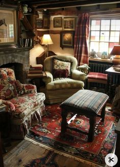 a living room filled with furniture and a fire place under a window next to a rug