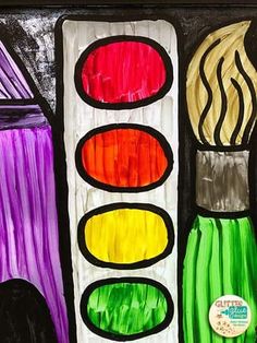 a close up of a stained glass window with different colored paint brushes and spoons