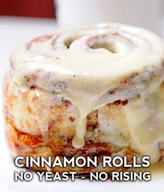 cinnamon rolls with icing on a white plate