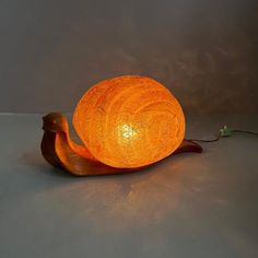 an orange lamp sitting on top of a table