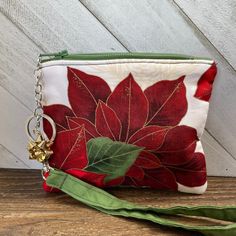 "Poinsettia Zipper Bag, Winter Wristlet Pouch, Christmas Coin Bag, Change Purse, Keychain Pouch, Gold Accents, Small Lined Pouch If your days look anything like mine, then this small fabric Poinsettia zipper coin pouch is going to help save the day. This Christmas theme change purse is designed to help keep your small essentials in one place to help keep you a little more organized. Great to just grab and go for a short trip to the market. Or, it's small enough to throw it into your larger bag. Handheld Zipper Pouch Cosmetic Bag As Gift, Handheld Zippered Pouch As Gift, Red Zipper Pouch Wristlet For Gift, Red Zipper Pouch Wristlet As Gift, Red Wristlet With Zipper Pouch As Gift, Pouch Wristlet With Zipper Closure For Gift, Handheld Pouch With Zipper Closure As Gift, Red Wristlet With Zipper Closure As Gift, Red Wristlet Gift