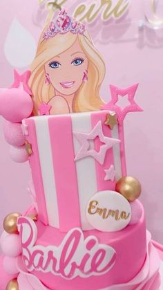 a barbie doll birthday cake with pink and white frosting, gold accents and stars