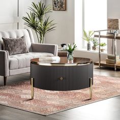 a living room filled with furniture and a rug on top of a hard wood floor