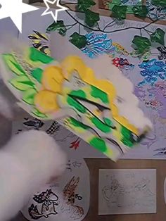 a person is flying through the air with their hand in front of some paper art