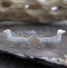 Small artisan handmade Dachshund dog silhouette stud earrings. The Details ∞ Artisan handmade jewelry ∞ Small Dachshund (approx 11x6mm) ∞ Choose from sterling silver, 14k gold-filled or solid 14k yellow gold ∞ Earring backs included in the metal of your choice ∞ Made to order ∞ Gift box included ∞ Made in the USA Is 14k gold-filled right for you? If you are purchasing our gold filled stud earrings please keep in mind they are cut from a sheet of 14k gold filled metal. The front and back of the s Small Dachshund, Dachshund Silhouette, Artisan Jewelry Handmade, Dog Silhouette, Small Gift Boxes, Wiener Dog, Gold Filled Earrings, Gold Earring, Dachshund Dog