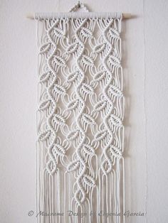 a white wall hanging on the side of a wall