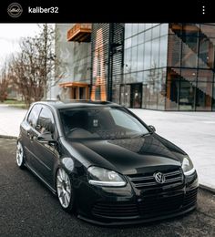 a black car parked in front of a building