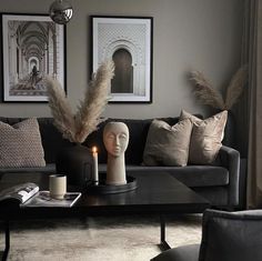 a living room filled with furniture and a candle on top of a wooden coffee table