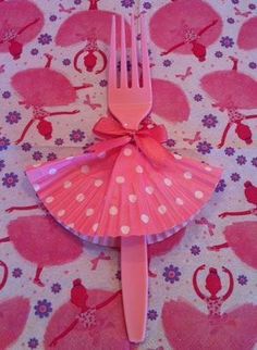 a pink plastic fork with a bow on it