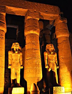 an image of some statues in the dark