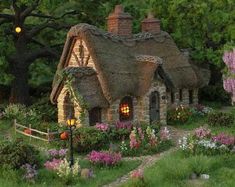 a painting of a cottage with flowers and trees in the background