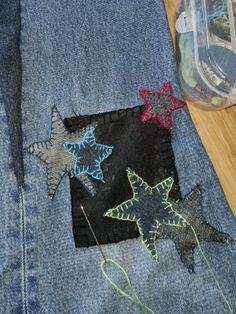 a pair of jeans with embroidered stars on them