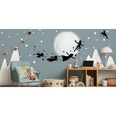 a child's room with a large wall mural featuring the silhouettes of tinkerbells flying in front of a full moon