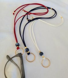 Spectacle chain Spectacle holder Sunglasses necklace Glasses holder Eyeglasses holder This beautiful necklace with a ring for glasses is made of suede cord in red, white and dark blue. In the center of the necklace is a ceramic, blue bead 10 mm in size. The gold ring is 20 mm in diameter and you can put any glasses on it. Gold components are 24 k gold color brass. At the end of the necklace is a bead that you move and adjust the length. The length is adjustable and you can get a length of 15 to 25 inches. If you buy this necklace, it comes in a nice gift bag. All shipments are sent by registered mail with a security tracking code. Thank you so much for visiting! FREE SHIPPING! Eyeglasses Necklace, Spectacle Holder, Glasses Holder Necklace, Eyeglass Holder Necklace, Turquoise Jewelry Boho, Chain Sunglasses, J Necklace, Sunglasses Necklace, Eyeglasses Holder