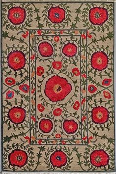 an old rug with red flowers and leaves on the border, in front of a white background