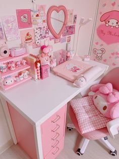 a pink desk with hello kitty decorations on it and a teddy bear in the chair