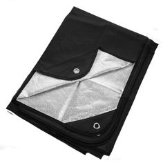 an open black and white bag on a white surface with the bottom section folded up