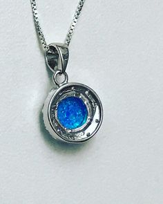 "Blue Opal Halo Necklace Minimalist and Dainty Necklace Metal: All components are made from solid .925 Sterling Silver Stone: 8mm Lab Created Opal; Cubic Zirconia Measurement: Pendant Height is 19mm (0.75\") including bail and 13mm (0.51\") wide Choose Chain Length Please feel free to Convo me with any questions before purchasing. Please view policy before purchasing Other Opal Necklaces can be found here https://www.etsy.com/shop/LinksAndStones?ref=ss_profile&section_id=24284450 Thank You F Nickel Free Round Pendant For Formal Occasions, Nickel-free Round Pendant For Formal Wear, Nickel-free Round Pendant For Formal Occasions, Formal Nickel-free Round Pendant Jewelry, Sterling Silver Birthstone Jewelry For Formal Occasions, Silver Birthstone Necklace With Polished Finish As Gift, Silver Pendant Birthstone Necklace For Wedding, Formal Sterling Silver Round Birthstone Necklace, White Gold Sterling Silver Round Birthstone Necklace