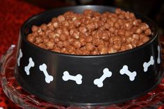 a black bowl filled with dog food on top of a table