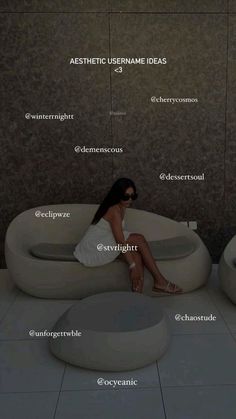 a woman sitting on top of a white couch in front of a wall with names