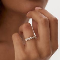 a woman's hand with a diamond ring on her finger