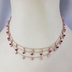 14 Karat Yellow Gold Triple Strand Gemstone Necklace-  This lovely piece features natural pink sapphires (medium pink), pink tourmaline stones (light pink) and synthetic spinel stones(dark pink) set on a 14K triple chain cable necklace.   Beads measure 6mm each.  Stamped: 14K  Size: 15 inches  Weight:  6.2 dwt. / 9.7 gr.  Very good condition, professionally polished.  Will come packaged in a gift box or pouch (when possible) and will be shipped U.S. Priority Mail Insured.  JAGI ID 1/31/24 Flat Gold Necklace, Light Weight Necklace, Chanel Pendant, Pink Stone Necklace, Peridot Necklace, Necklace Beads, Pink Set, Medallion Necklace, Tourmaline Stone