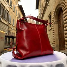 "This bag has been made of the best genuine leather by local master crafters of Florence in Italy, designed for women who only accept premium Italian quality and luxury leather bags and modern Italian fashion. . Sizes: Width: 27 cm / 10.7 inches Height: 31 cm / 12.2 inches Depth: 13 cm / 5.2 inches Color: Red . The story of this bag: In the enchanting city of Florence, renowned for its artistic heritage and exquisite craftsmanship, a tale unfolds about an elegant leather bag that captures the essence of Italian luxury. Handcrafted with utmost care and attention to detail, this premium leather bag embodies the timeless allure of Florence. Every stitch, every fold, and every delicate touch in the creation of this Florence leather bag is a testament to the skilled artisans who pour their pass Elegant Everyday Leather Backpack With Smooth Grain, Elegant Soft Leather Backpack For Daily Use, Elegant Leather Backpack With Smooth Grain, Elegant Leather Backpack As Shoulder Bag In Soft Leather, Elegant Leather Satchel Backpack, Elegant Leather Crossbody Backpack, Elegant Soft Leather Shoulder Bag Backpack, Elegant Soft Leather Backpack Shoulder Bag, Elegant Soft Leather Shoulder Backpack